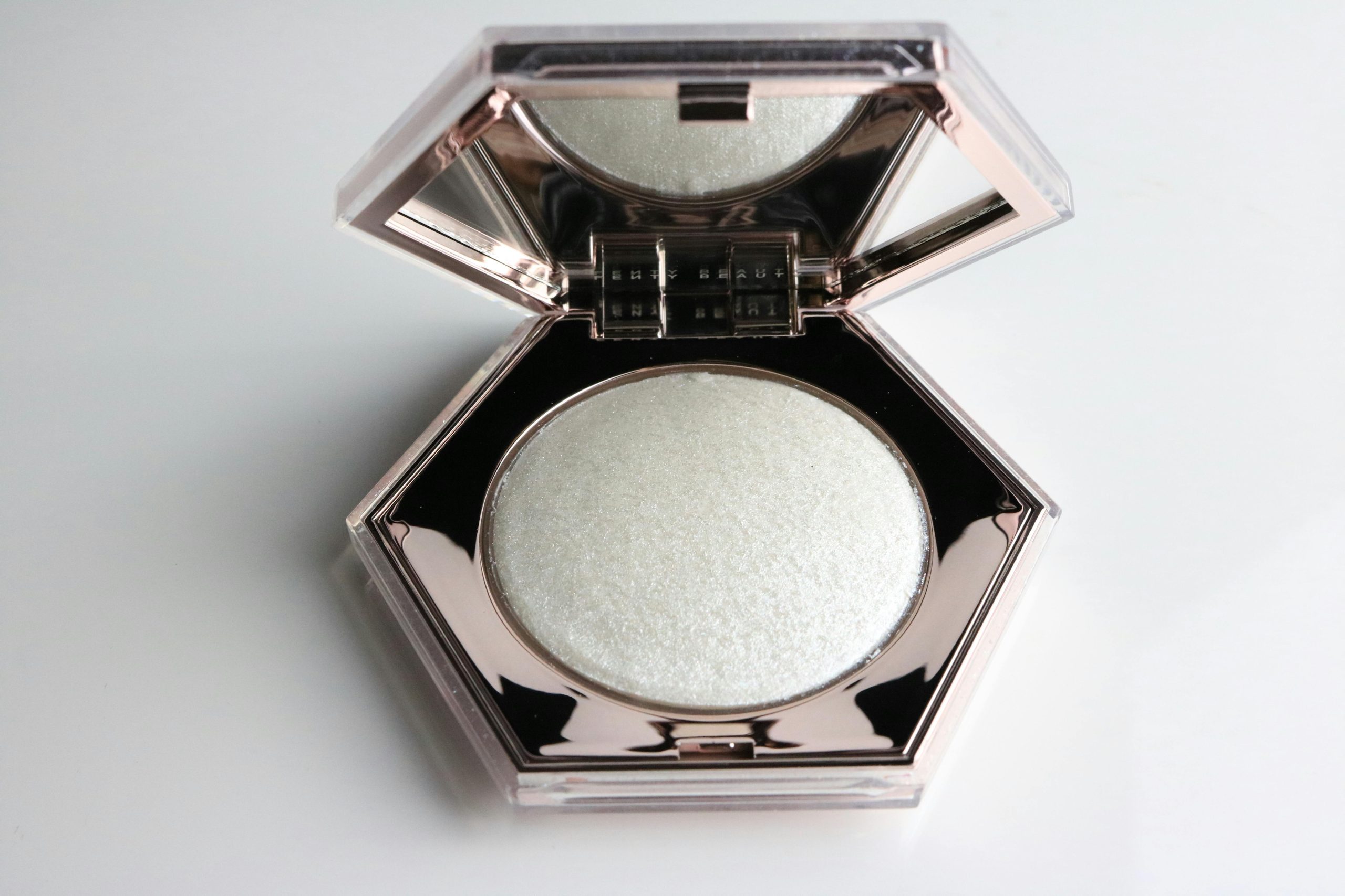 Close-up shot of a reusable metal compact filled with pressed powder