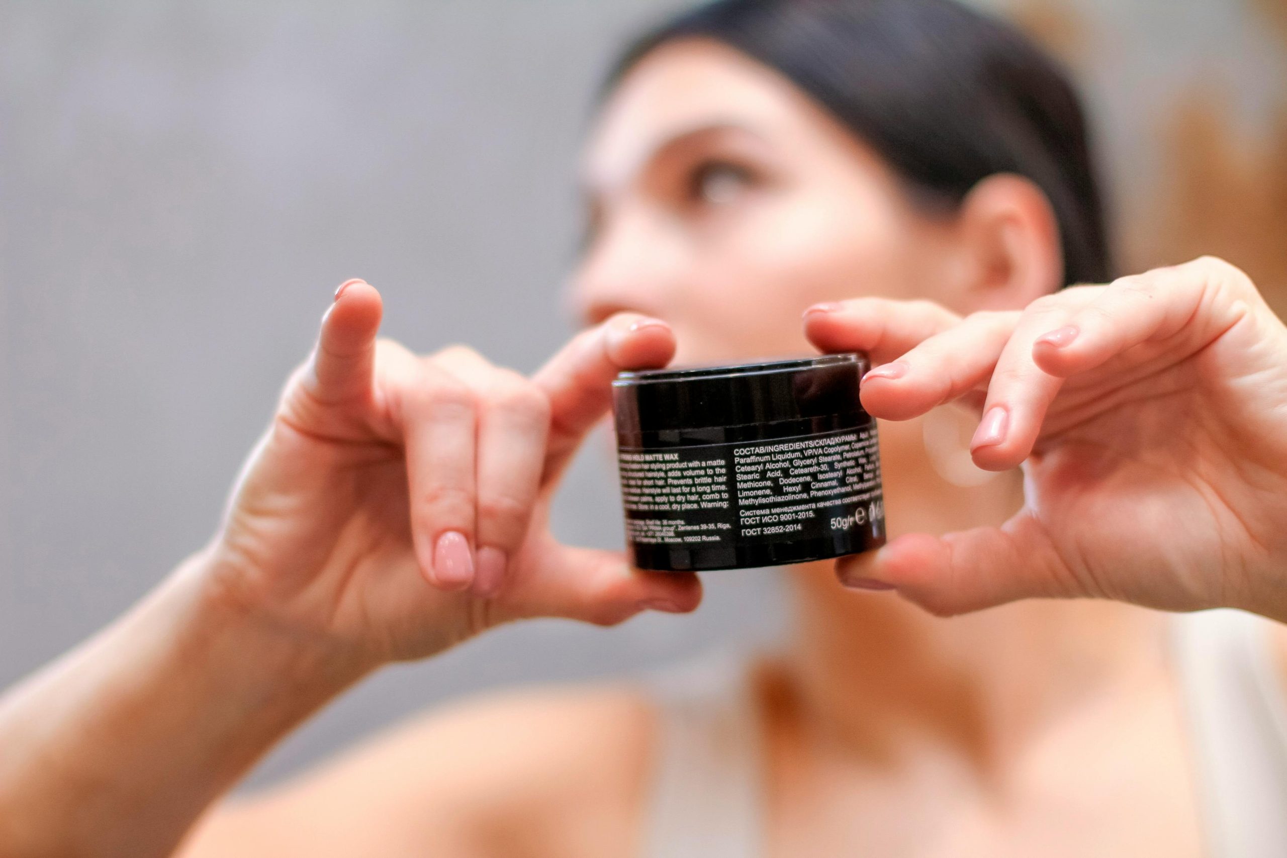 Woman checking skincare product label
