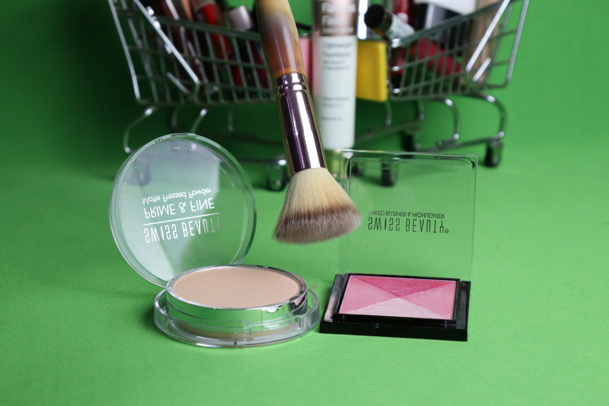 A palette of biodegradable makeup surrounded by leaves