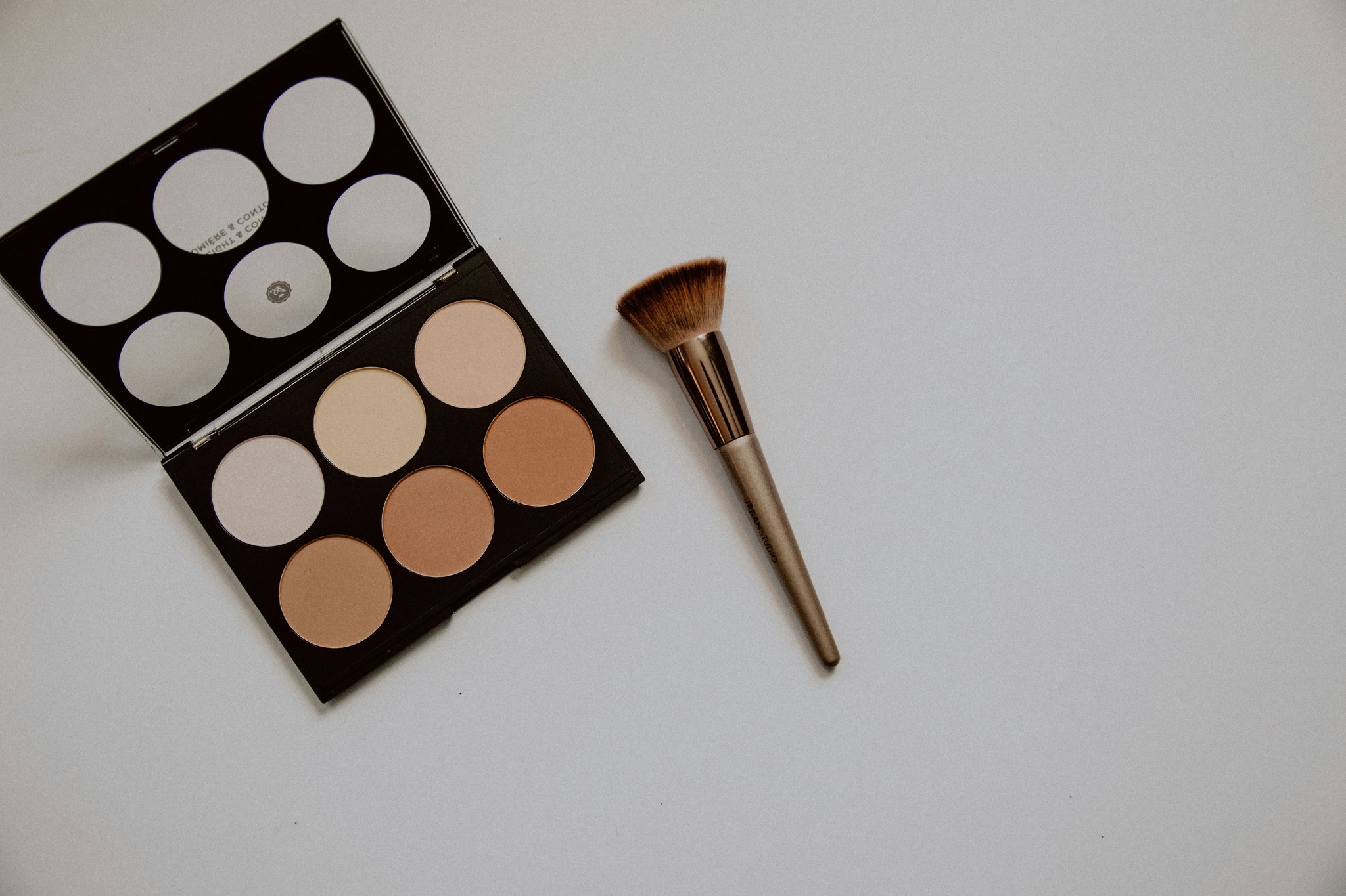 Before-and-after photo comparing heavy makeup versus natural makeup with organic powder
